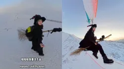 Woman dressed as a witch paraglides with broomstick