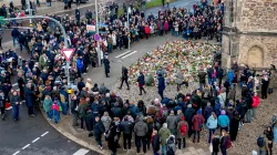 Mourners laid flowers near the scene of the deadly Christmas market attack. 