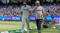 Akash Deep going into the dressing room with the team physio.