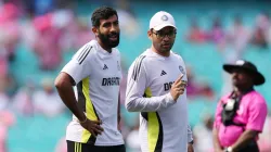 Jasprit Bumrah with a support staff member.