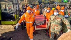 Security and rescue personnel carry the body of one of the workers trapped inside a coal mine at Umrangso area amid the ongoing rescue operations