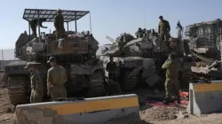 Israeli soldiers work in a staging area on the Israel-Gaza border after returning from the Gaza Strip, Saturday, Jan. 18, 2025, a day ahead of a ceasefire between Israel and Hamas. 