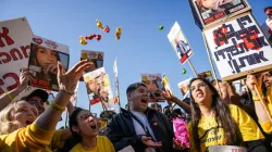 People react as they watch broadcast of the release of Israeli soldier Agam Berger.