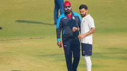 Virat Kohli with Delhi coach Sarandeep Singh.