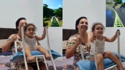 Mother uses chair to give daughter roller coaster ride