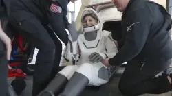 Sunita Williams smiles, waves while stepping out of spacecraft after return to earth.