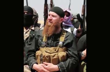 File photo of Omar al-Shishani standing next to the group's spokesman