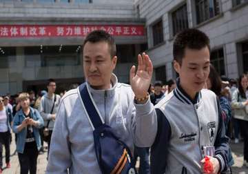 Sun Wenlin and his partner Hu Mingliang leave court after losing their case.