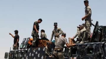 File photo shows Iraqi security forces backed by Shiite and Sunni