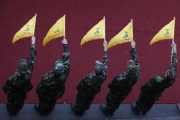 Hezbollah fighters hold flags