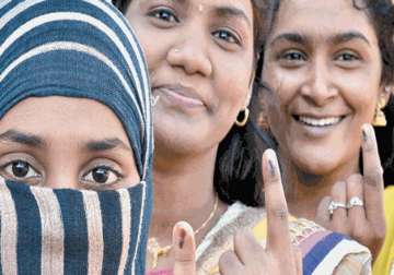 Women gather to vote outside a polling booth in Chennai, Tamil Nadu