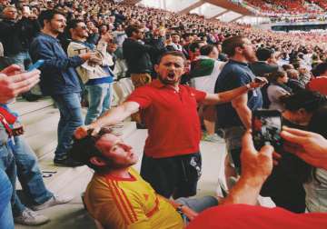 Fan falls asleep among cheering spectators