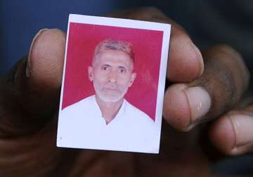 A relative showing the photograph of Mohammad Akhlaq