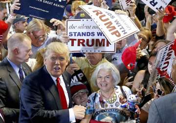 Republican presidential candidate Donald Trump with a supporter in Phoenix