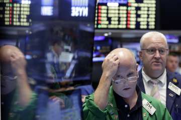 Traders at New York Stock Exchange react after stocks plunged