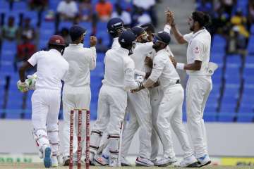 Indian players celebrate win of fall of a West Indies' wicket