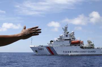 Philippines navy personnel motions towards a Chinese ship  in South China Sea