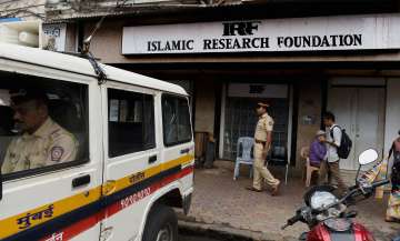 Police personnel outside the office of Islamic preacher Zakir Naik in Mumbai