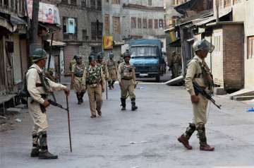 CRPF jawans patrolling a street during restrictions and strike in Srinagar 