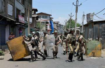 Security personnel remove barricades put up by protesters in Srinagar