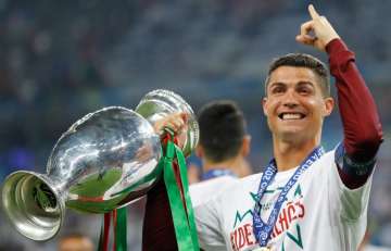 Ronaldo proudly holds the trophy at the end of the Euro 2016