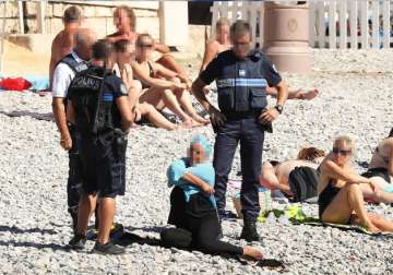 Armed men in France’s Nice force burkini-clad woman to remove part of clothing