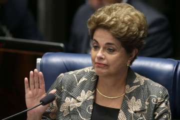 Suspended Brazilian President Dilma Rousseff waves goodbye after her impeachment