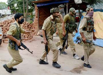 SoG of Jammu and Kashmir Police take position during an encounter with militants