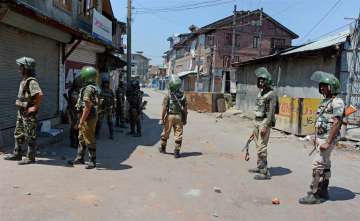 Security personnel stand guard in street during 41st day of curfew in Srinagar