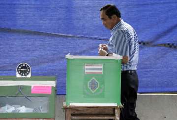 Thailand's PM Prayuth Chan-ocha prepares to cast his vote in a referendum 