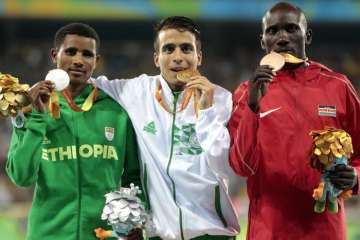 Abdellatif Baka centre shows off his gold medal alongside Tamiru Demisse left)