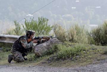 A soldier takes position near Army Brigade camp during a terror attack in Uri