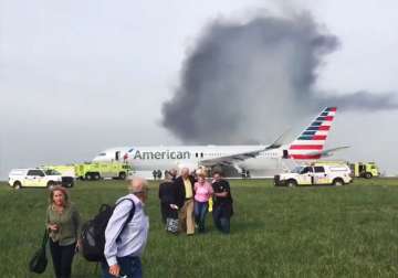 Passengers walk away from a burning American Airlines jet at at Chicago Airport.
