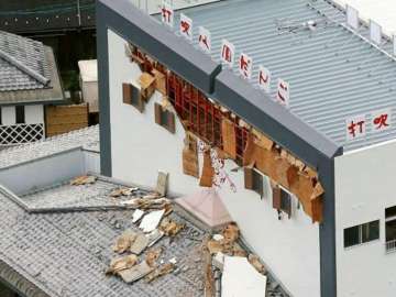 Debris fallen from damaged wall of a building scattered on rooftop in Kurayoshi