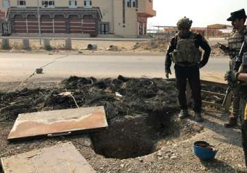 Iraq's elite counterterrorism force inspects a tunnel made by ISIS in Bartella.