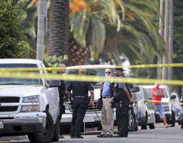 Police investigators work the scene of a fatal shooting in LA 