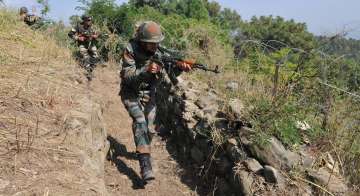 ndian army soldiers take positions during their patrol near the LoC in Nowshera