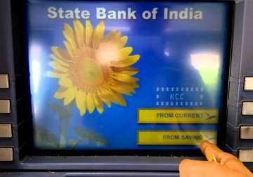 File pic - A man operates SBI ATM machine