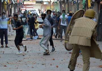 File pic - A jawan saves himself from protesting youths pelting stones at him