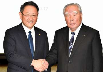 Akio Toyoda of Toyota and Osamu Suzuki of Suzuki Motors at a press conference.