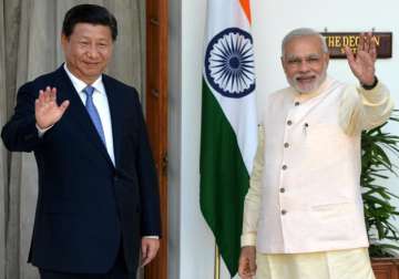 (File pic) Narendra Modi and Xi Jinping wave to media outside Hyderabad House.