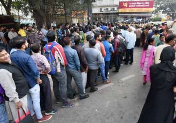 People stand in queue out a bank in New Delhi 