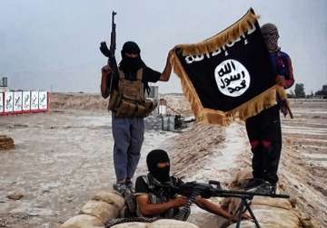 File pic - ISIS militants wave terror group's flag in Iraq 