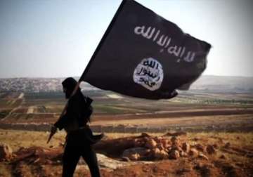 File pic - ISIS militant waves terror outfit's flag 