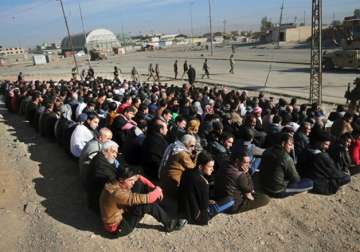 Scores of Iraqi male residents rounded up by the Iraqi army in Mosul.