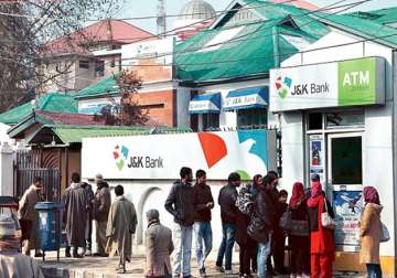 People stand in queue outside J&K bank ATM in Kashmir to withdraw cash