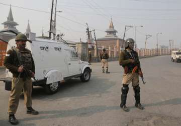 Indian paramilitary troopers stand guard outside Jamia Masjid in Srinagar