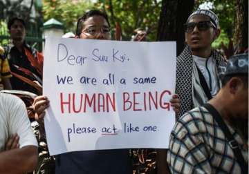 Protestor holds a placard during protest against persecution of Rohingya Muslims