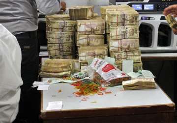 Officials count seized Rs 3.5 crore demonetised notes at Nagaland airport 