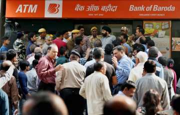 People scuffle to exchange Rs 500 and Rs 1000 notes at a bank in New Delhi 